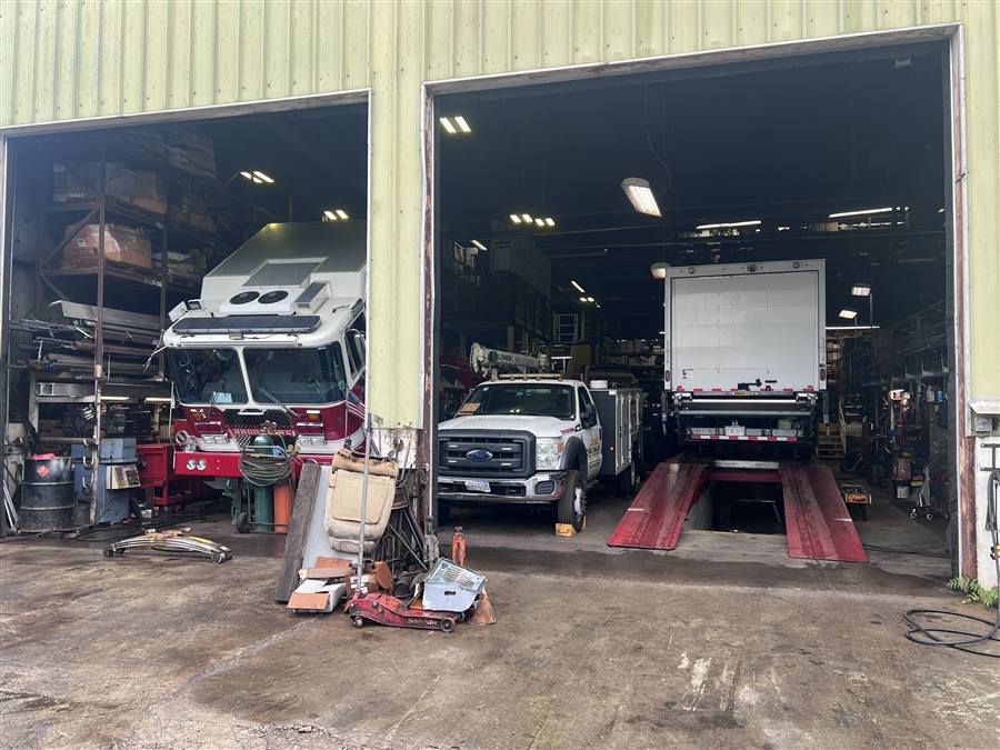 Palmer Spring Company's current Woburn, Massachusetts facility with open garage bay doors