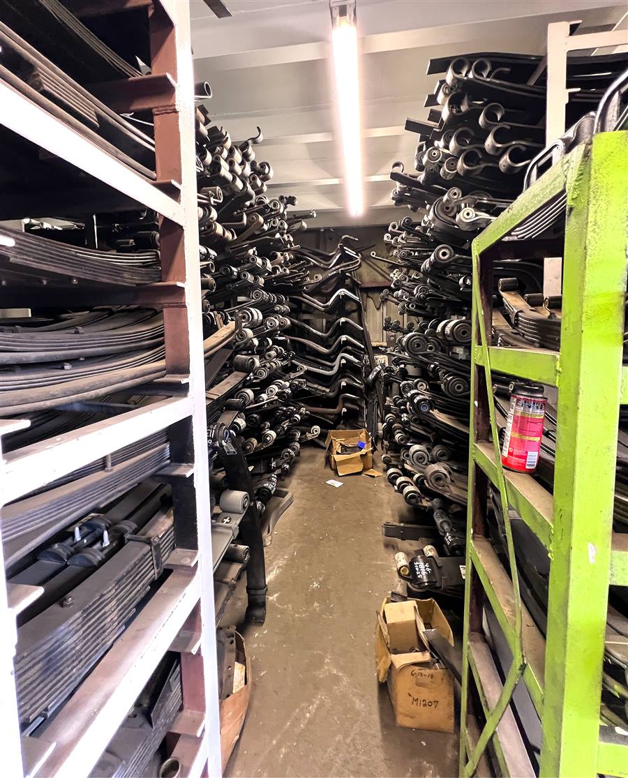 New heavy-duty suspension parts organized on warehouse shelving
