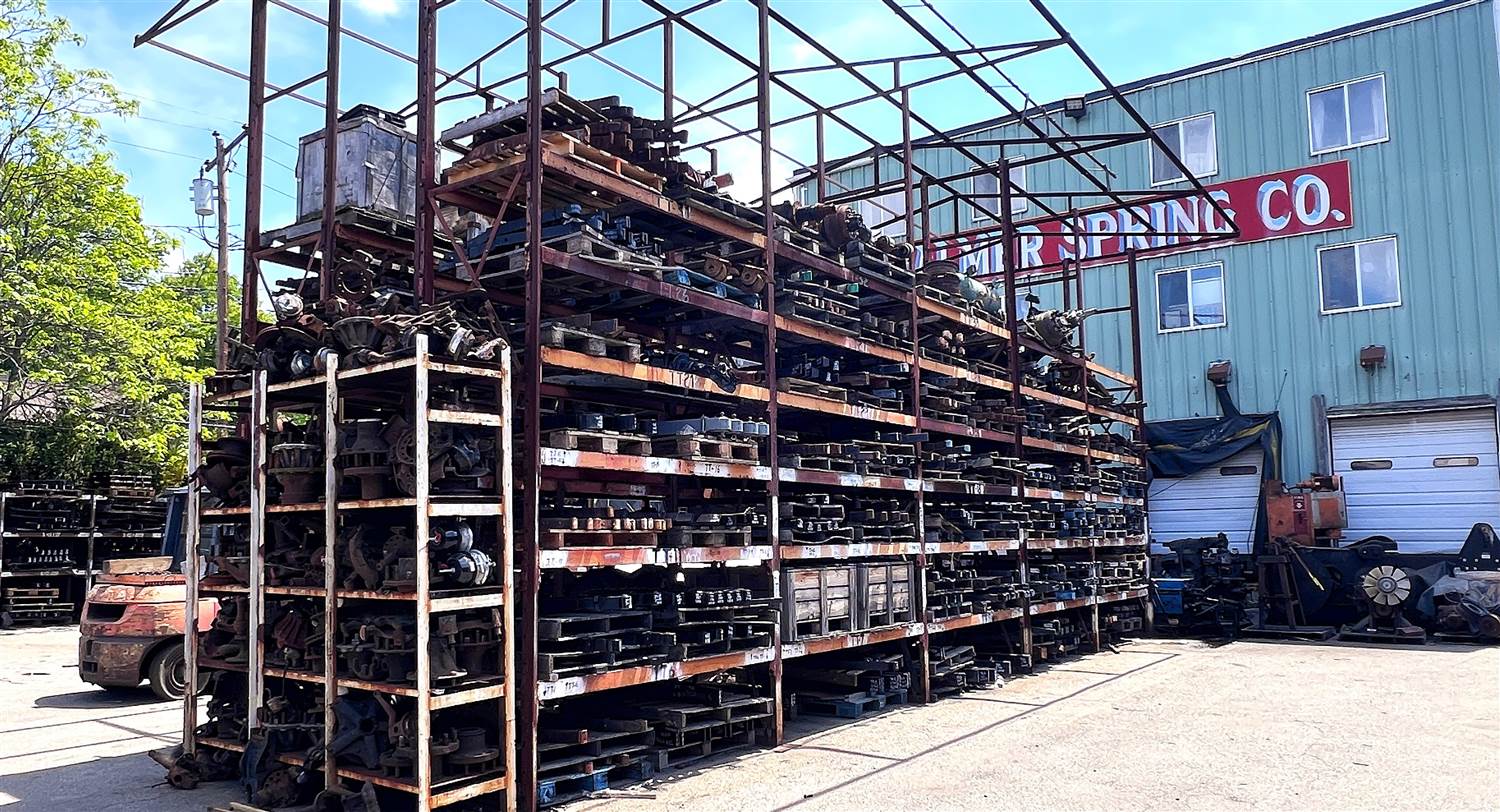 Palmer Spring Company outdoor parts yard with company signage