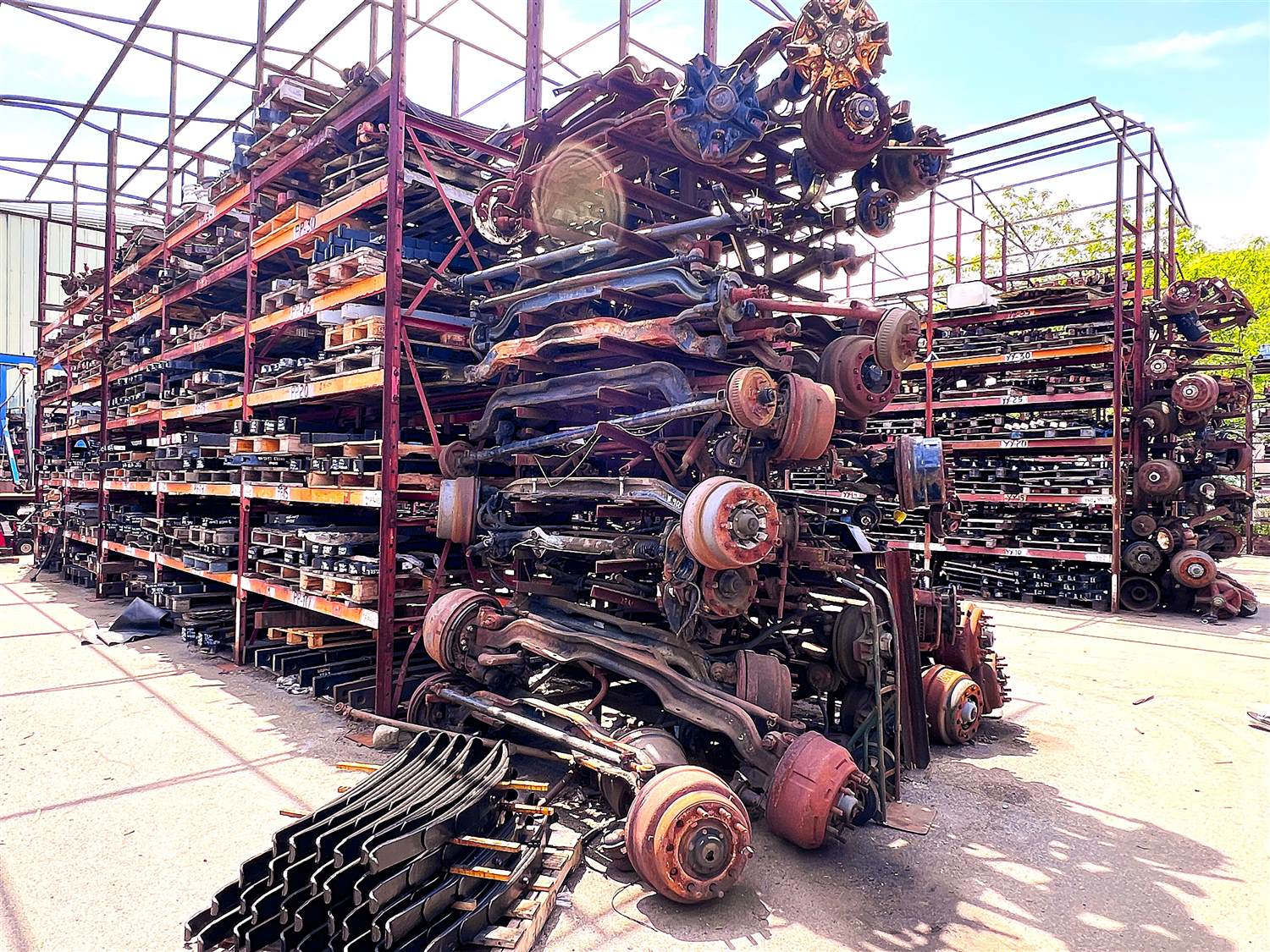 Weathered outdoor storage rack of used heavy-duty truck parts