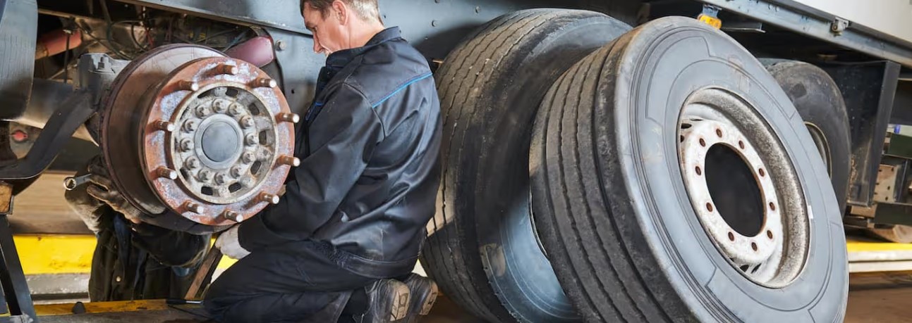 Palmer Spring Company technician servicing a heavy-duty truck brake drum